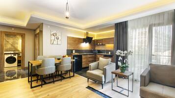 A modern living room with a dining area, a sofa, and a small table with a plant.
