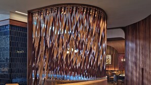 A reception desk with a wooden finish and the name "IDOL WOLF" on it. - 21C Museum Hotel St Louis  (St. Louis)