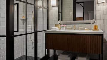 A modern bathroom with a glass-enclosed shower, a wooden vanity, and a large mirror.