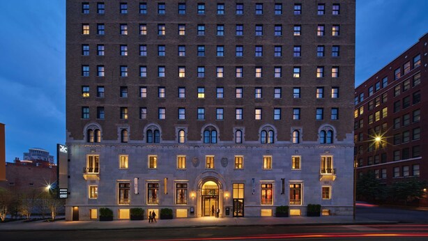 A multi-story building with a symmetrical facade, large windows, and a central entrance with a canopy. - 21C Museum Hotel St Louis  (St. Louis)
