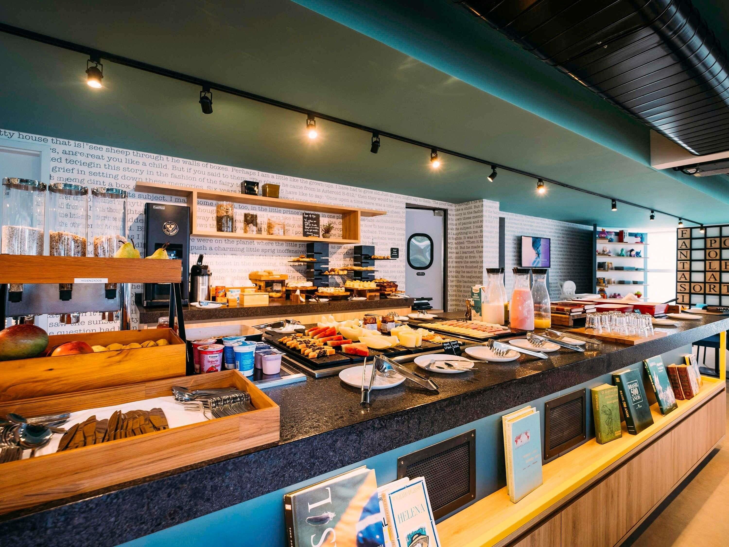 A buffet area with various food items and a selection of books on the counter.