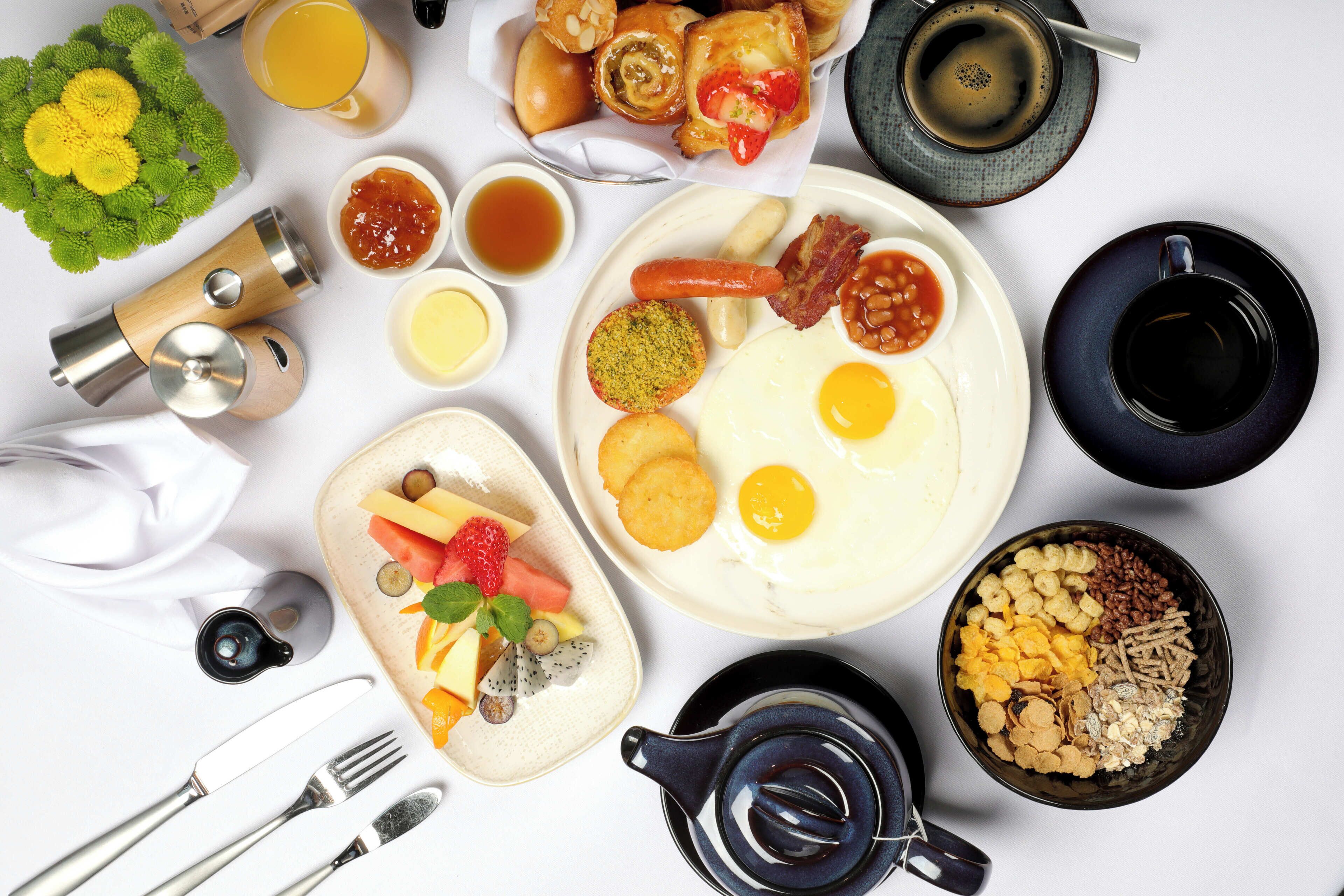 A breakfast spread with various foods and drinks.