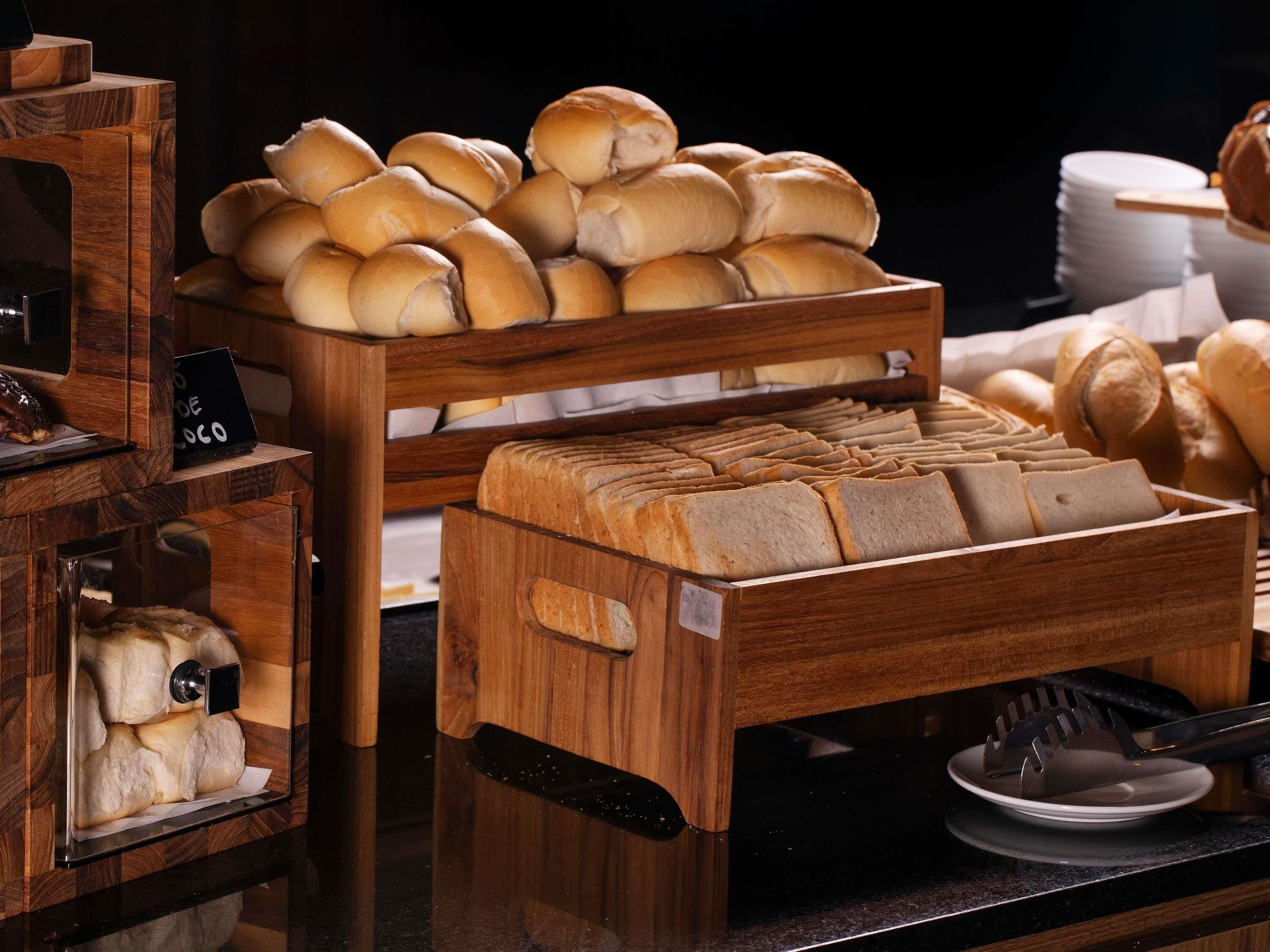 A bakery display with various breads and pastries.