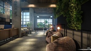 Un espacio de oficina moderno con amplios ventanales, un mostrador de recepción, asientos cómodos y una pared verde.