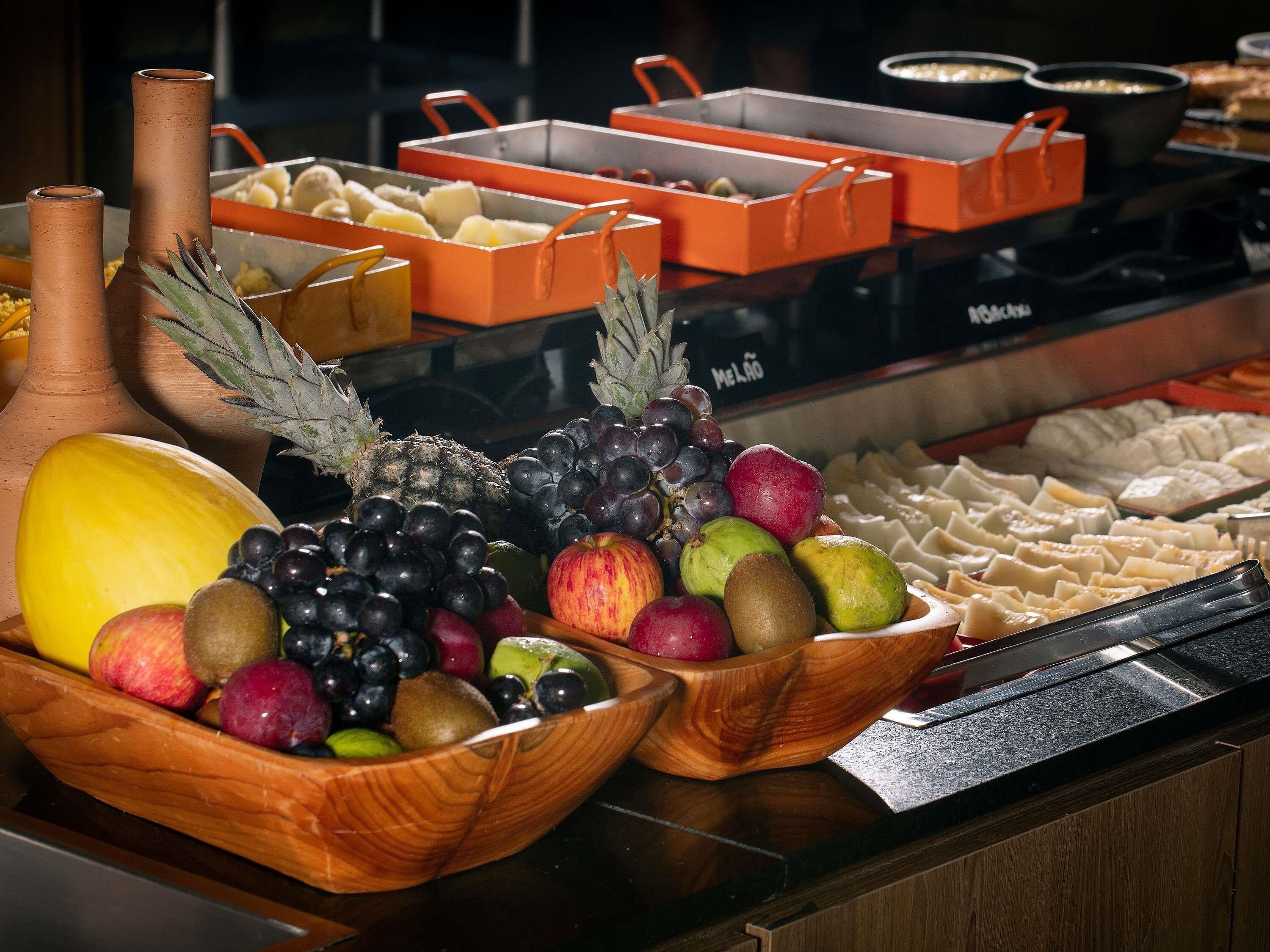 A buffet with various food items and a selection of fruits and vegetables.