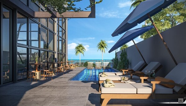 Utendørsbasseng og solsenger