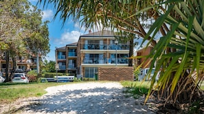 Stunning multi-story building with modern design, brick and glass facades, and spacious balconies.