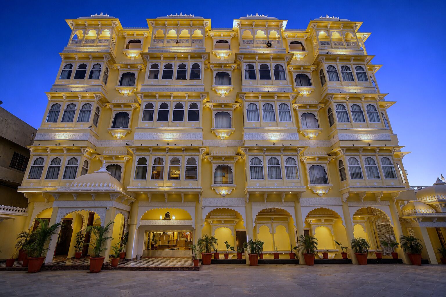 A multi-story building with a traditional architectural style, featuring multiple balconies and arched windows.