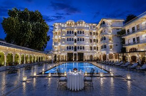 A large, ornate building with a pool and outdoor seating. - Amar Mahal Luxury Boutique Hotel Near Fateh Sagar Lake, Udaipur (Udaipur)