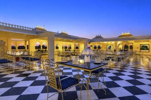 A hotel courtyard with checkered flooring, outdoor seating, and traditional architecture. - Amar Mahal Luxury Boutique Hotel Near Fateh Sagar Lake, Udaipur (Udaipur)