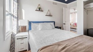 A bedroom with a bed, bedside tables, a wardrobe, and a window with curtains. - LakeView Getaway: Lake views & hot tub! (Lexington)