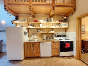 A kitchen with wooden cabinets, a refrigerator, a dishwasher, a stove, and a microwave. - Alpine View Cabin - duplex unit B w/ queen bedroom (Winthrop)