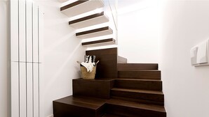 A modern staircase with dark wooden steps and white walls. - Genteel Home Atocha II (Madrid)
