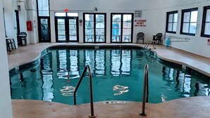 An indoor swimming pool with clear water, metal handrails, and a 3 ft depth marker. - Great Ocean Front Condo in Heart of Myrtle Bech (Myrtle Beach)