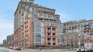 A multi-story residential building with balconies, large windows, and a mix of brick and glass facades. - Spectacular Terrace - City/Lake View - 5 mins from major attractions (Toronto)