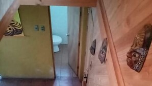 A wooden staircase leading to a bathroom with a toilet and a sink. - hermosa casa con piscina olmue (Olmue)