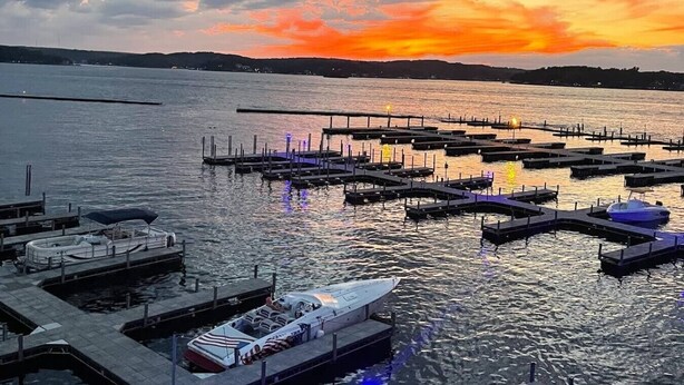 A marina with docks and boats, a clear sky, and a sunset. - The Lucky Minnow  • Pools, Hot Tub, Deck, Grill (Village of Four Seasons)