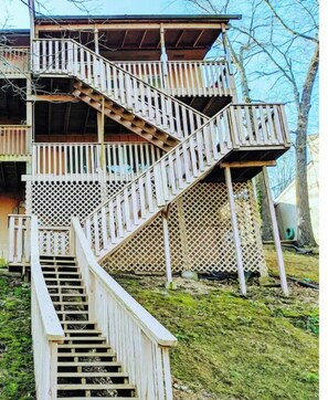 Staircases lead to spacious balconies with lattice railings on lower levels and solid railings above.