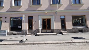 A building with multiple windows and a door, numbered 5, with signage for 'TRICK HAIR' and 'FAB'. - 2ndhomes Bright & Spacious City Studio (Helsinki)