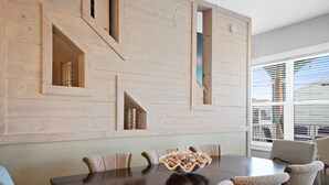 A dining area with a dark wooden table, leopard print chairs, and a decorative bowl on the table. - Beach House - Dreams Come True by PHG (Panama City Beach)