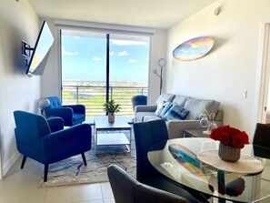 Relax in this stylish living room with a breathtaking city view, comfortable sofa, and elegant armchair.