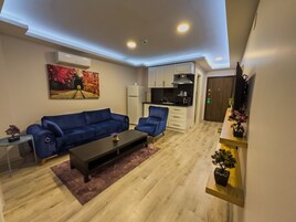 Family Suite, 2 Bedrooms, City View | Living area | 32-inch flat-screen TV with satellite channels