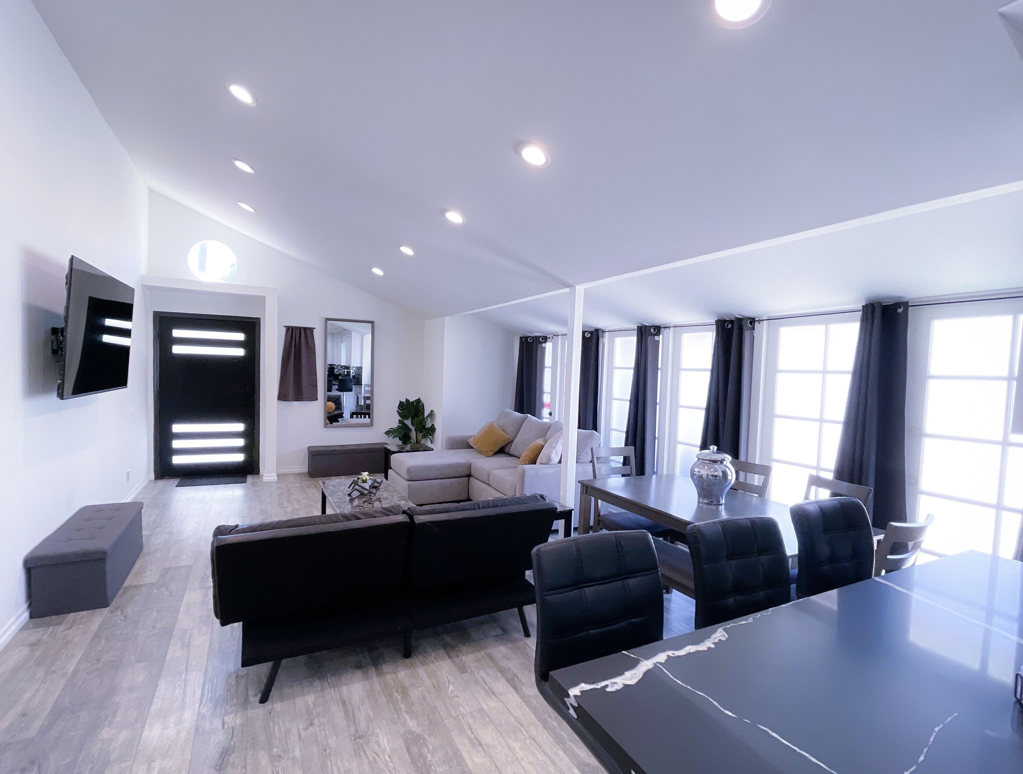 Living room with open island connected kitchen space