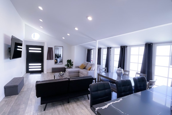 Living room with open island connected kitchen space