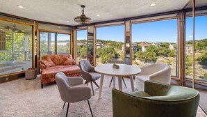 A spacious room with a large window offering a view of the surrounding landscape. - Lake Travis Gem, Golf, boat, Tennis, Pool (Point Venture)