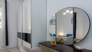 A modern bathroom with a bathtub, a vanity with a mirror, and a small plant on the counter. - Holiday Home Apios - Three Bedroom Holiday Home with Swimming Pool (Benkovac)