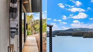 A wooden pathway leading to a balcony overlooking a lake with a forested hill in the background. - Piccolo Segreto Lake Conjola (Lake Conjola)