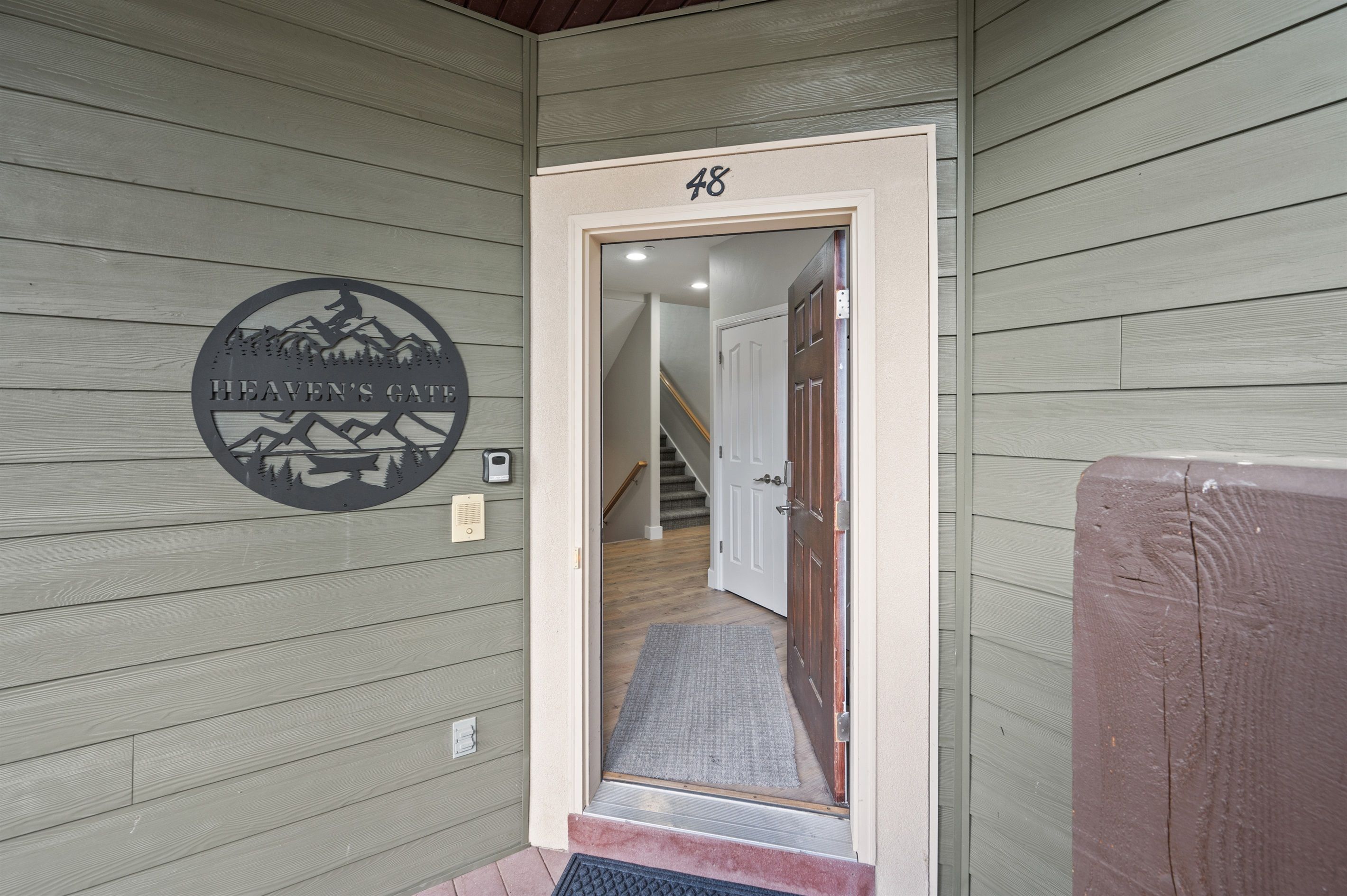 A wooden exterior wall with a number '48' and a logo for 'Heaven's Gate'.