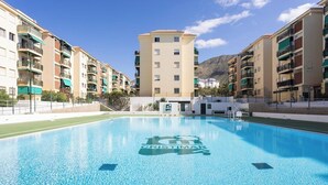 A swimming pool with a building in the background. - Home2Book Comfy Seaside Apartment Cristimar, Pool (Los Cristianos)