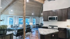 A spacious kitchen with dark wooden cabinets, a granite countertop, and a large island. - Echo Summit Cabin: Hot Tub, 1mi to Sierra at Tahoe (Twin Bridges)