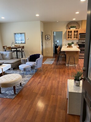Relax in a comfortable living space with a sofa, armchairs, and dining table.