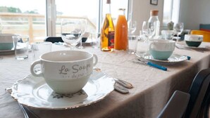 A dining table set with a white cup labeled "La Soupe du jour" and various glassware. - Avel Vaez - Charming house at 2 steps from the Aber Wrach (Landéda)