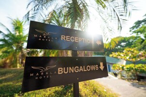 A sign for Marala Hotel with directions to the Reception and Bungalows.