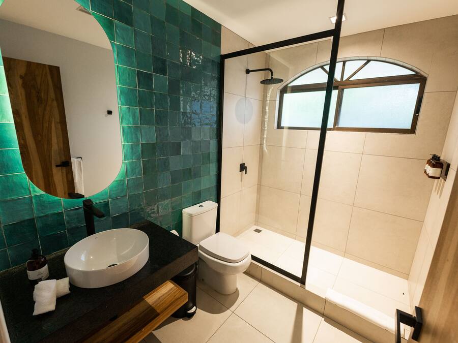 A modern bathroom with a freestanding bathtub, a large mirror, and a sink.