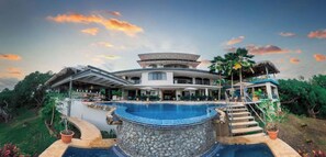 A modern resort with a central pool, a covered outdoor area, and a multi-level structure. - Marala Hotel (Parrita)