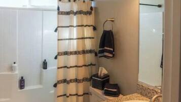 A bathroom with a bathtub, toilet, and sink.