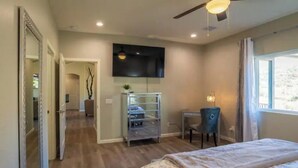 A bedroom with a bed, a desk, a chair, a TV, and a wardrobe. - Prescott Perfection,  elegant 3 bedroom home (Prescott)