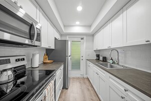 Superior 1-Bedroom King w/ Kitchen & Sofa Bed | Private kitchen | Full-size fridge, microwave, oven, stovetop