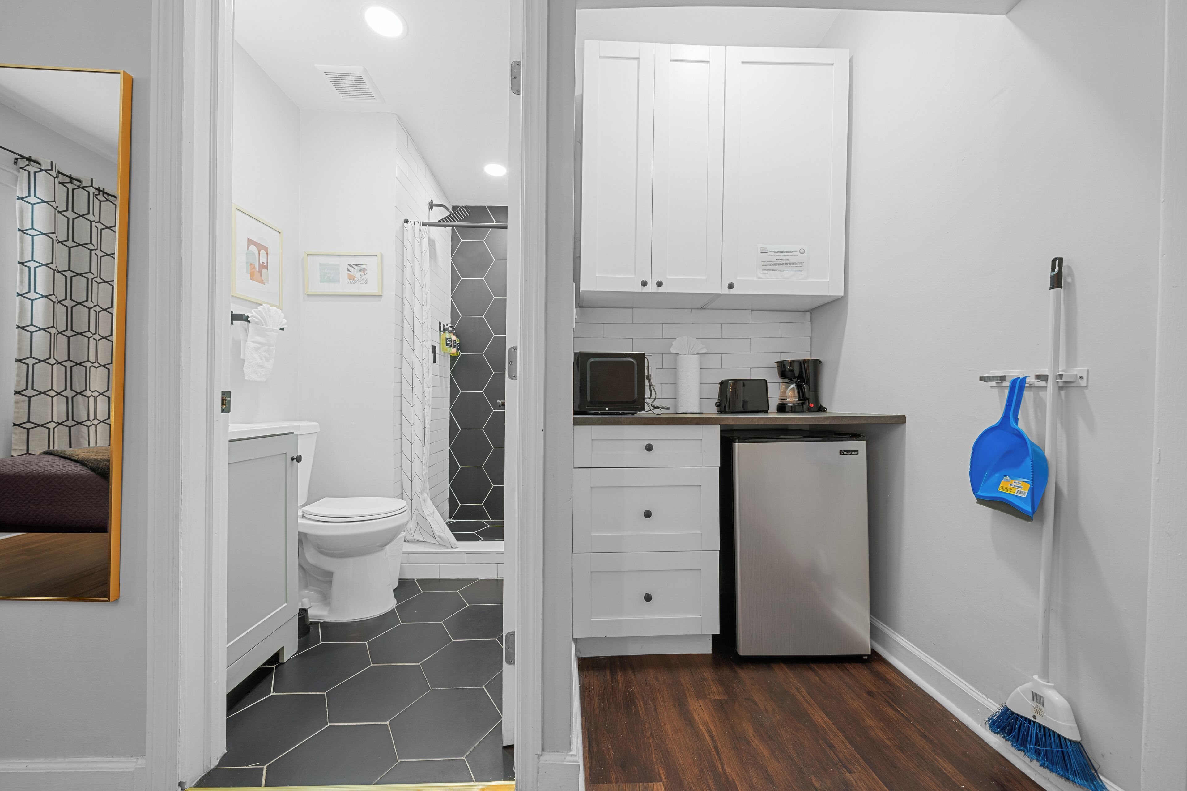 A modern bathroom with a toilet, shower, and sink.