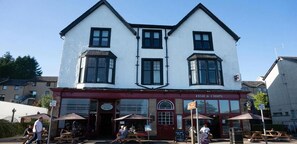 A two-story building with a sign for 'Fish & Chips' on the ground floor.