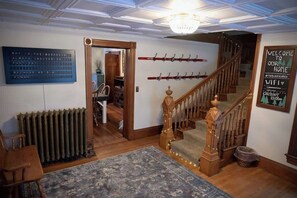 Una escalera con barandillas de madera y un rellano alfombrado.