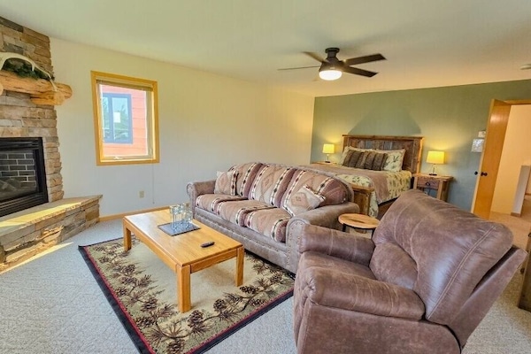 Large Master Suite with queen bed, seating area with pullout, a twin bed, ensuite bathroom and oversized garage