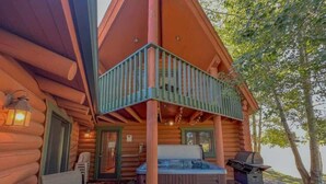 A log cabin with a hot tub, outdoor seating, and a grill on the deck. - Bison Turf- Hot Tub-Views - Close to Downtown (Red Lodge)