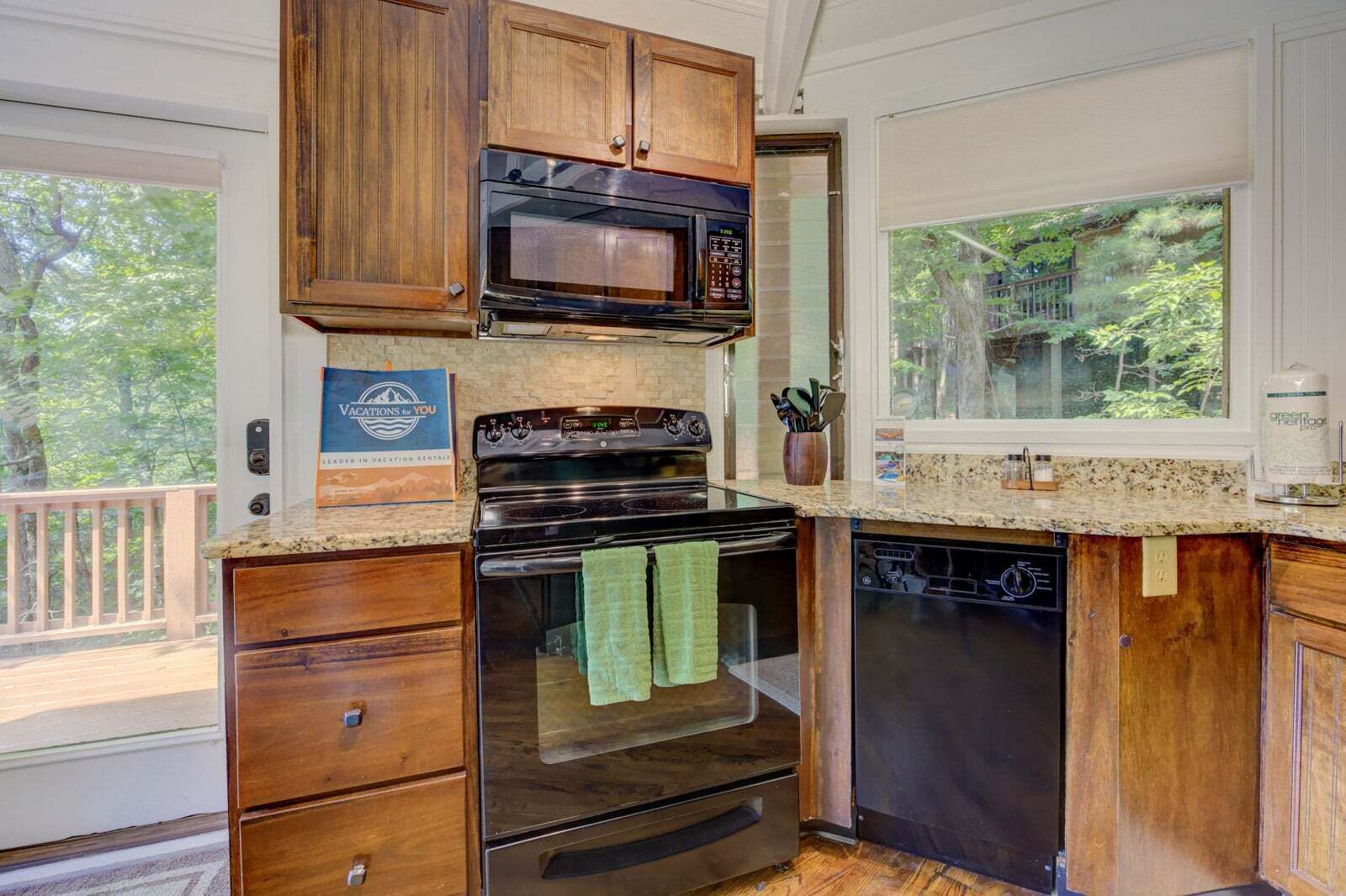 A kitchen with wooden cabinets, a microwave, an oven, and a dishwasher.