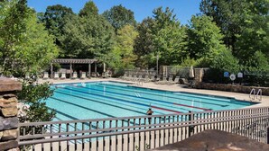 A rectangular swimming pool with a wooden deck area, surrounded by trees and a covered pavilion. - Chalet 141 - Pet Friendly, Wooded Views + Big Canoe Community Access (Jasper)
