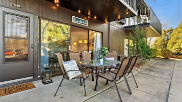 A modern building with a glass door, a sign reading "Stay Awake," and a dining area with a table and chairs.